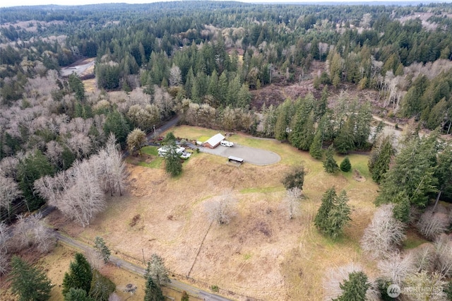 birds eye view of property with a view of trees