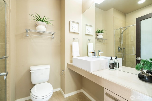 bathroom with sink, toilet, and a shower with door