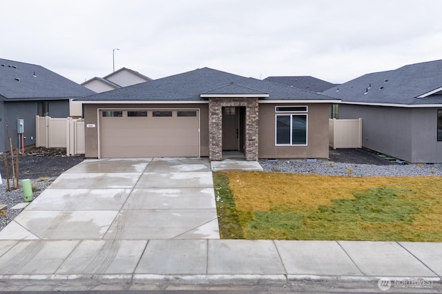 view of front of property featuring a garage, driveway, a shingled roof, and stucco siding