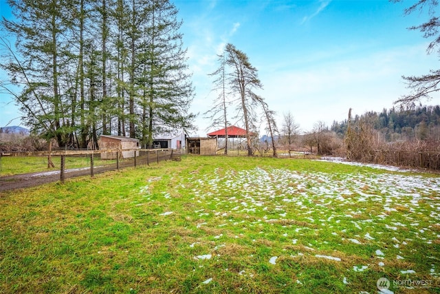 view of yard featuring a rural view and fence