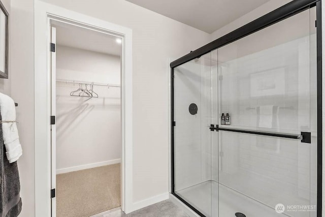 bathroom featuring a shower with door