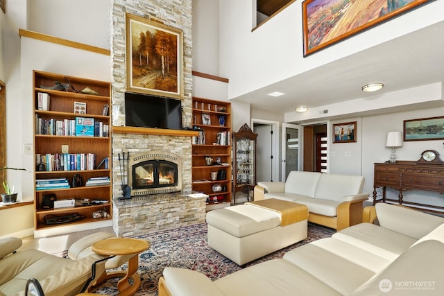 living room featuring a fireplace and a towering ceiling