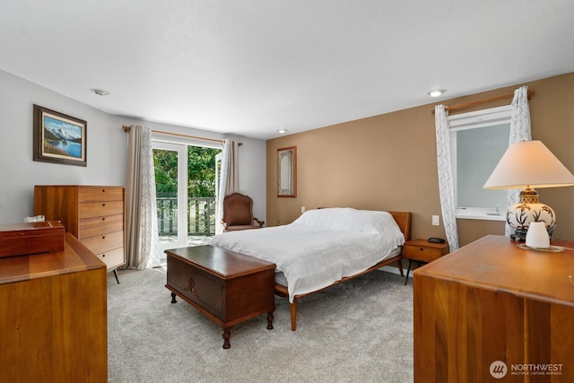 bedroom featuring access to outside and light colored carpet