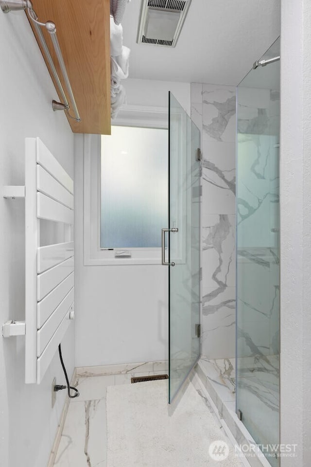 full bath with marble finish floor, visible vents, and a marble finish shower