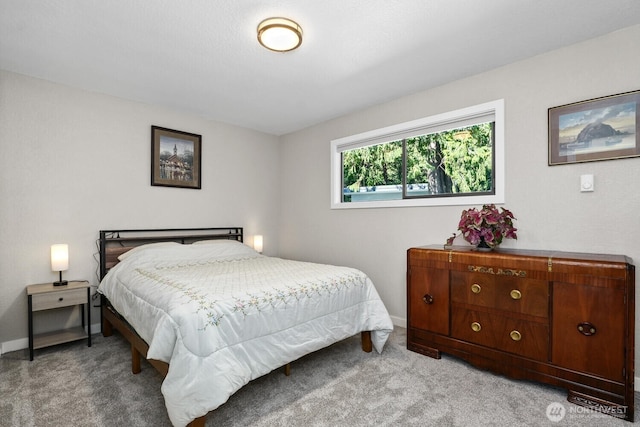 bedroom with light carpet and baseboards