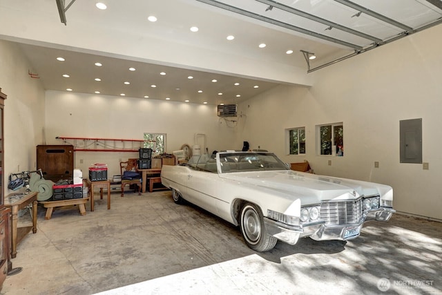 garage with electric panel and recessed lighting