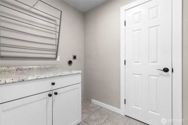 bathroom with marble finish floor and baseboards