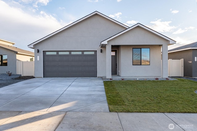 view of front of house featuring an attached garage, stucco siding, concrete driveway, and a front yard