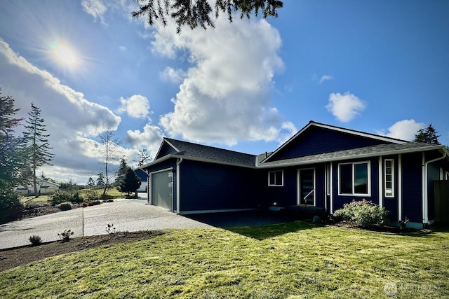 view of front of house with a garage, a front lawn, and concrete driveway