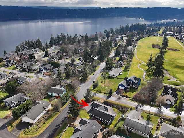 drone / aerial view with a water view and view of golf course