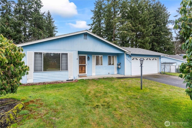 single story home with a garage, aphalt driveway, and a front lawn