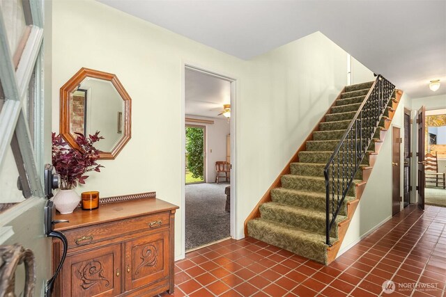 staircase featuring carpet floors and tile patterned floors