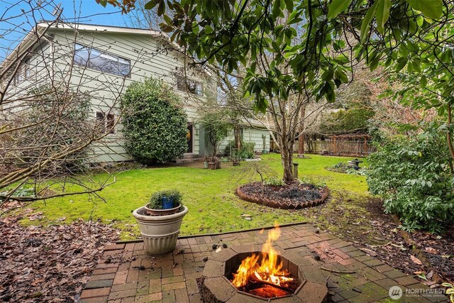 view of yard featuring fence and a fire pit