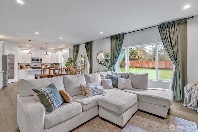 living room with recessed lighting and light wood-style floors