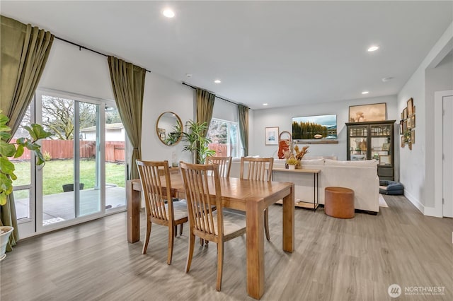 dining space with plenty of natural light, light wood-style flooring, baseboards, and recessed lighting