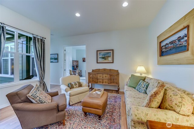 living room with recessed lighting, baseboards, and wood finished floors