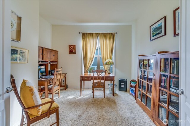 sitting room with carpet, french doors, and baseboards