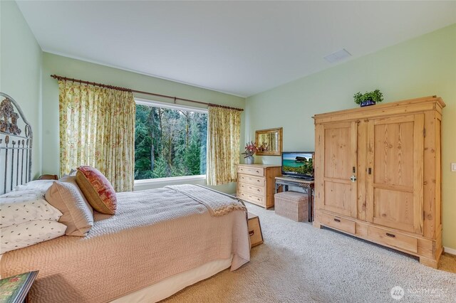 bedroom with light colored carpet and visible vents