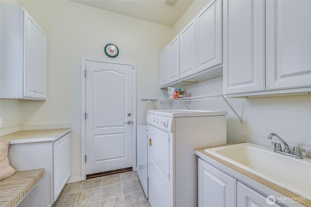 laundry room featuring cabinet space, separate washer and dryer, and a sink