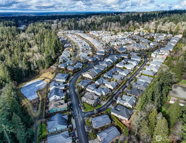 aerial view with a residential view and a wooded view