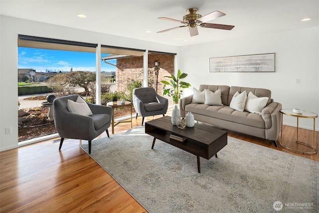 living room with ceiling fan, baseboards, wood finished floors, and recessed lighting