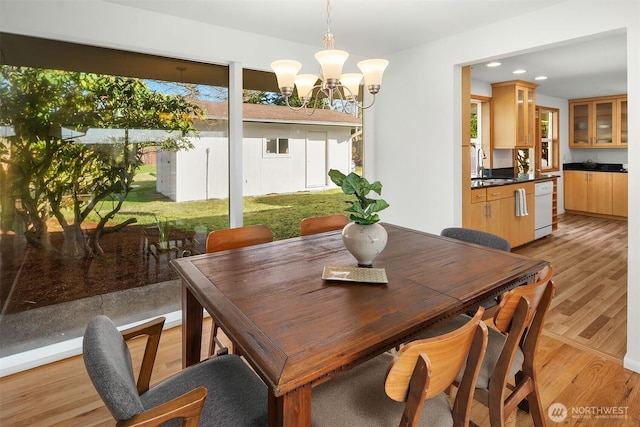 dining area with an inviting chandelier, light wood-style flooring, and recessed lighting