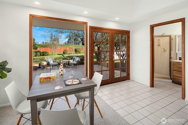 dining space with recessed lighting, light tile patterned flooring, and french doors