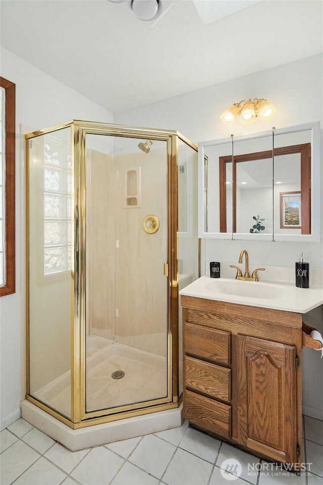 bathroom featuring a stall shower, tile patterned floors, and vanity