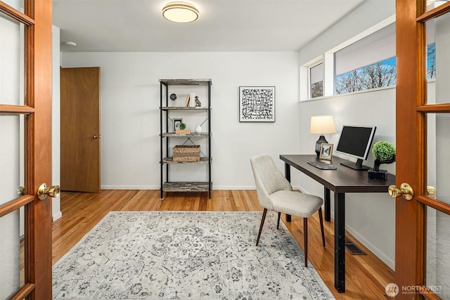 office featuring baseboards and wood finished floors