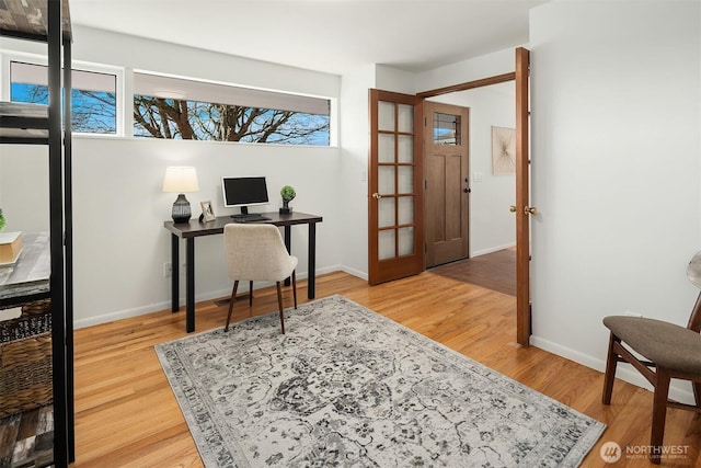 office area with wood finished floors and baseboards