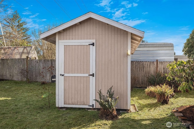 view of shed featuring a fenced backyard