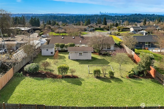 birds eye view of property featuring a forest view and a residential view