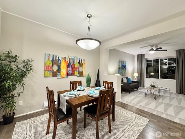 dining room with hardwood / wood-style flooring and ceiling fan