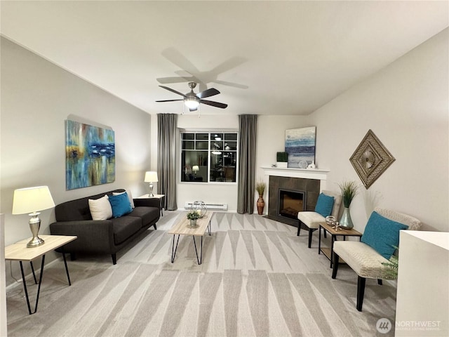 living room with a tile fireplace, carpet flooring, ceiling fan, and baseboard heating