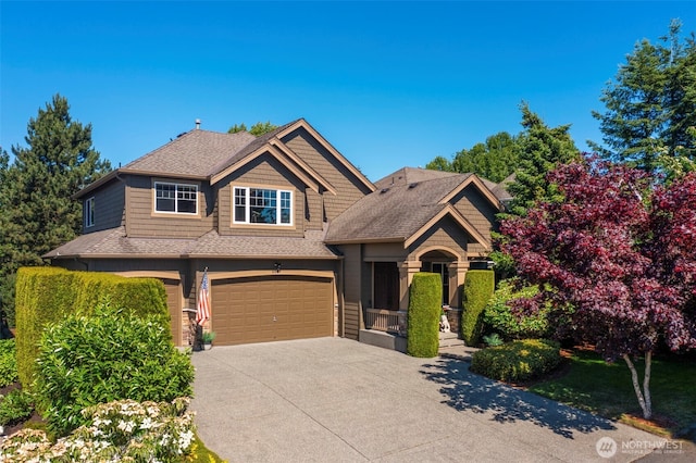 craftsman-style home with a garage, concrete driveway, and roof with shingles