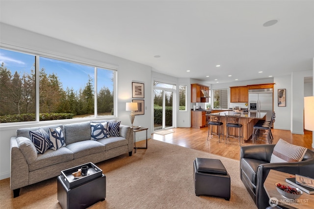 living room featuring light wood-style flooring and recessed lighting