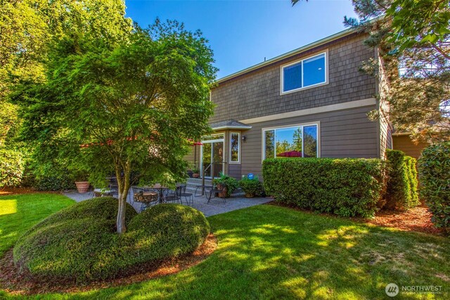 back of house featuring a patio and a yard