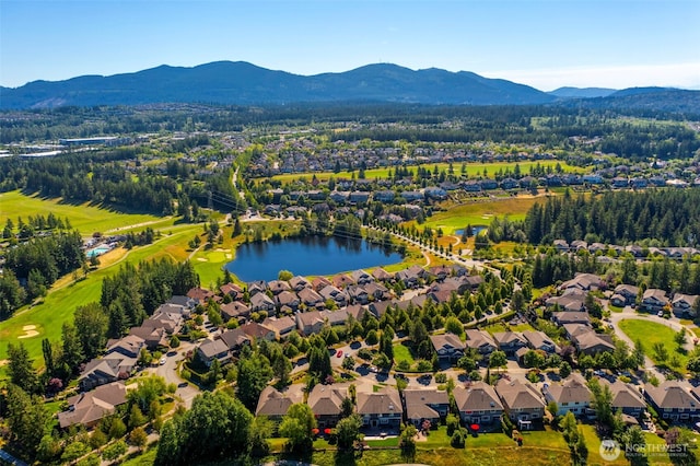 drone / aerial view featuring a residential view and a water and mountain view