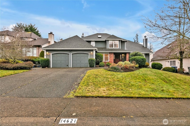 view of front of home featuring a garage and a front yard