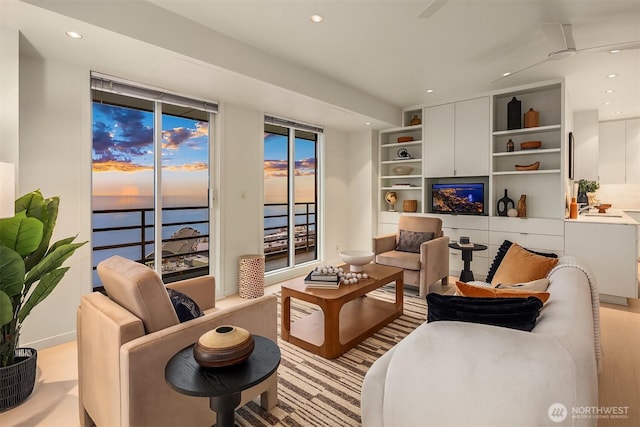 living area featuring built in shelves and recessed lighting