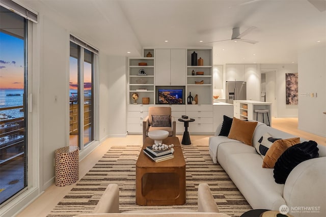 living area with ceiling fan and recessed lighting