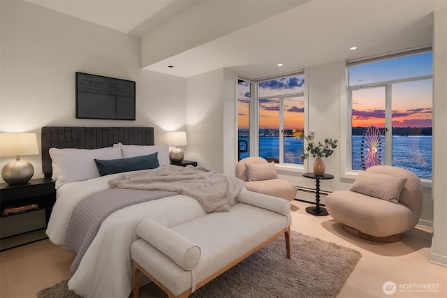 bedroom with a baseboard radiator, access to outside, and recessed lighting