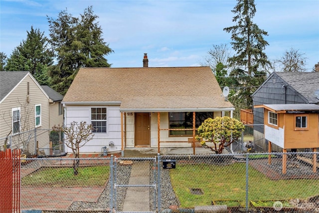 view of front of home featuring a shingled roof, a fenced front yard, a chimney, a gate, and a front lawn