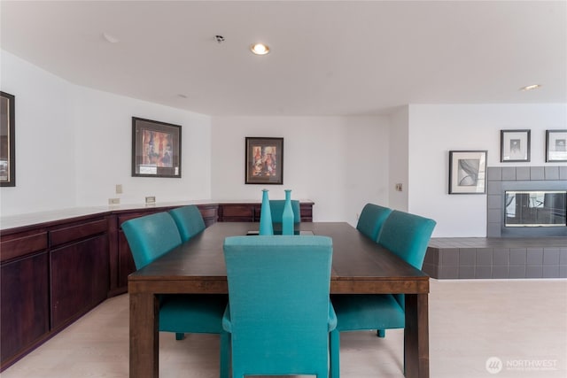 dining room featuring a tiled fireplace