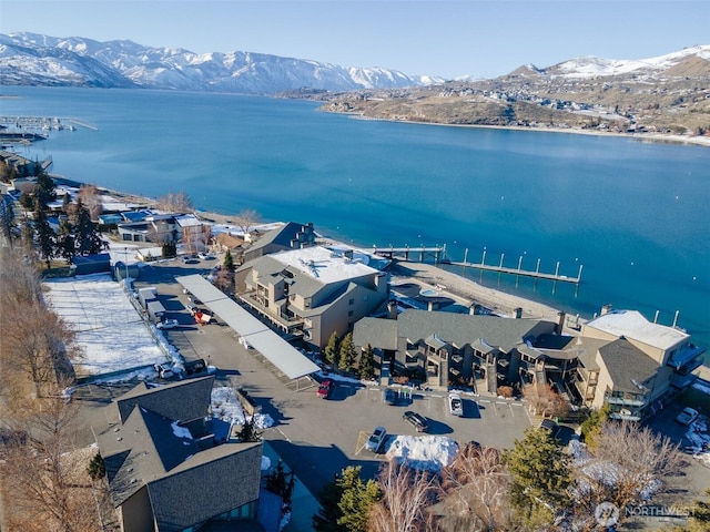 drone / aerial view featuring a water and mountain view