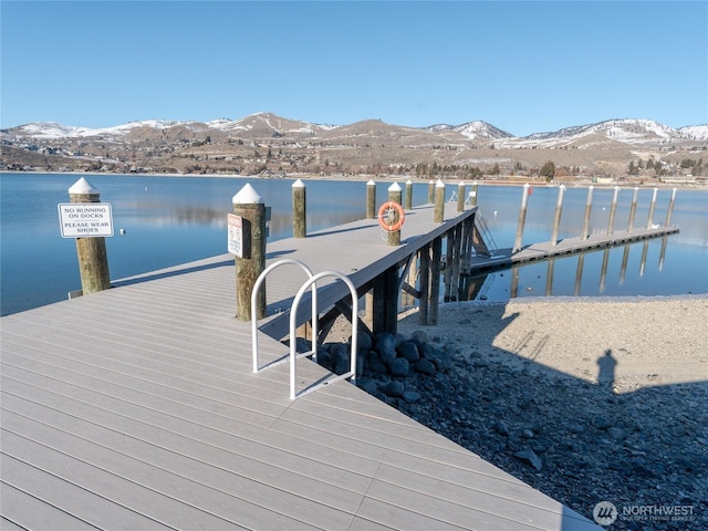 view of dock featuring a water and mountain view