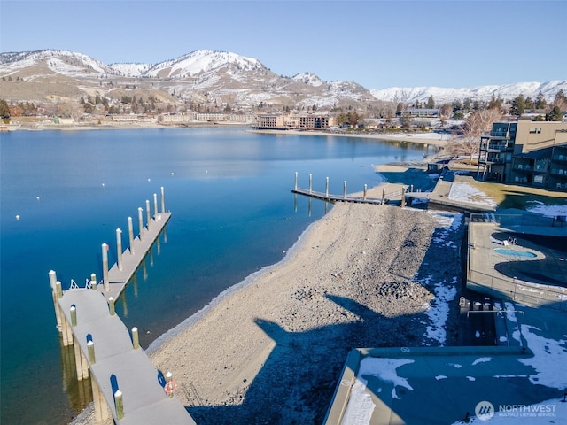 exterior space featuring a mountain view and a boat dock