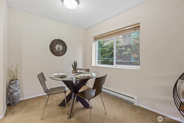 carpeted dining space featuring a baseboard radiator