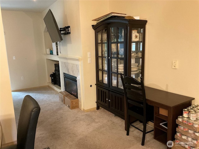 interior space with light colored carpet, a fireplace, and baseboards