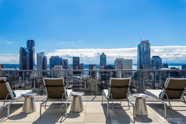 view of patio / terrace with a balcony and a view of city